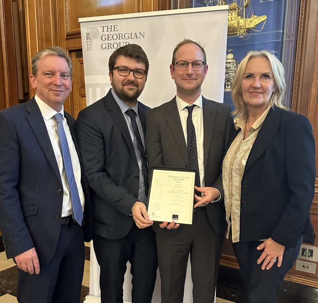 Pictured at the Georgian Group Architectural Awards 2024 ceremony: David Trevis-Smith, WWPT’s Project Manager, architects Dorian Proudfoot and Daniel Elkington, Donald Insall Associates; WWPT’s CEO Sarah McLeod OBE. The are smartly dressed and smiling at the camera.