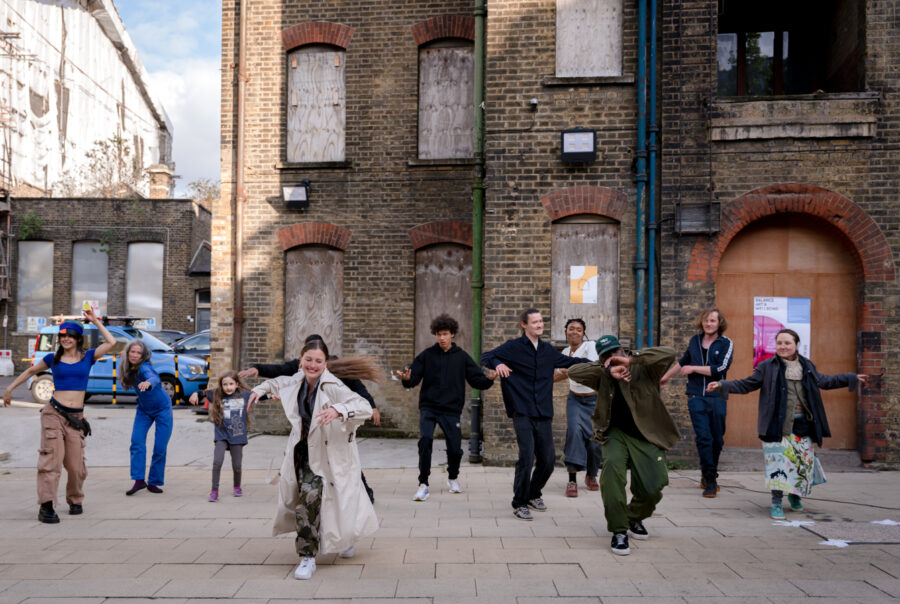A group of people dancing outside an old building