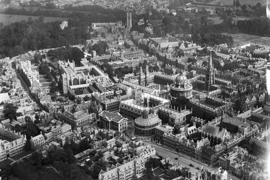 A black and white aerial photograph of a town.