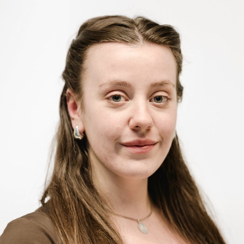 Phoebe facing the camera against a white background