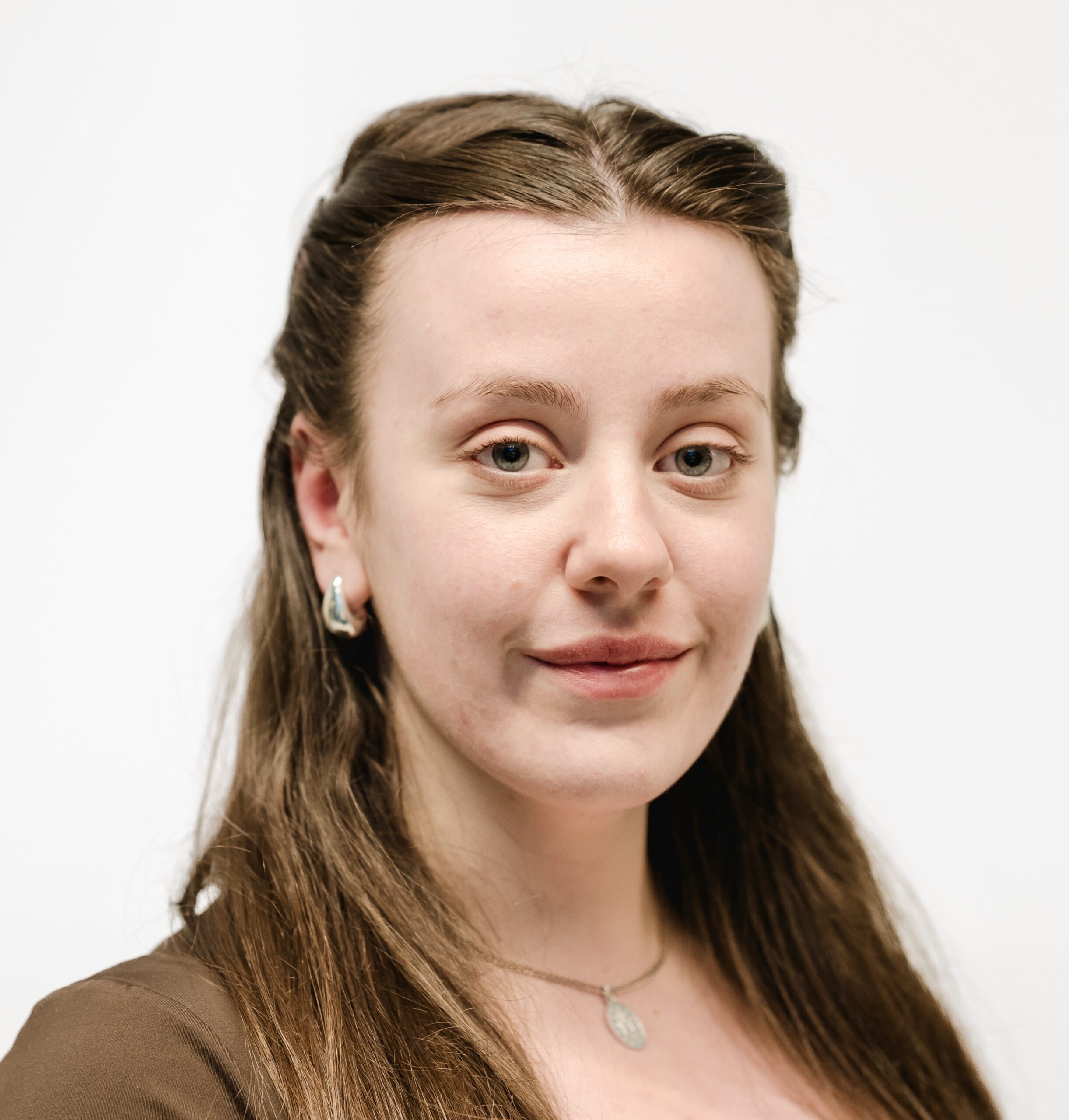 Phoebe facing the camera against a white background
