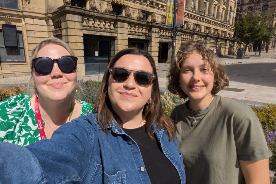 Charlotte, our Development and Outreach Officer for England, smiling in the sunshine in Bradford with Izabella, our Conference Organiser, and Sophie, our Heritage Trainee for England