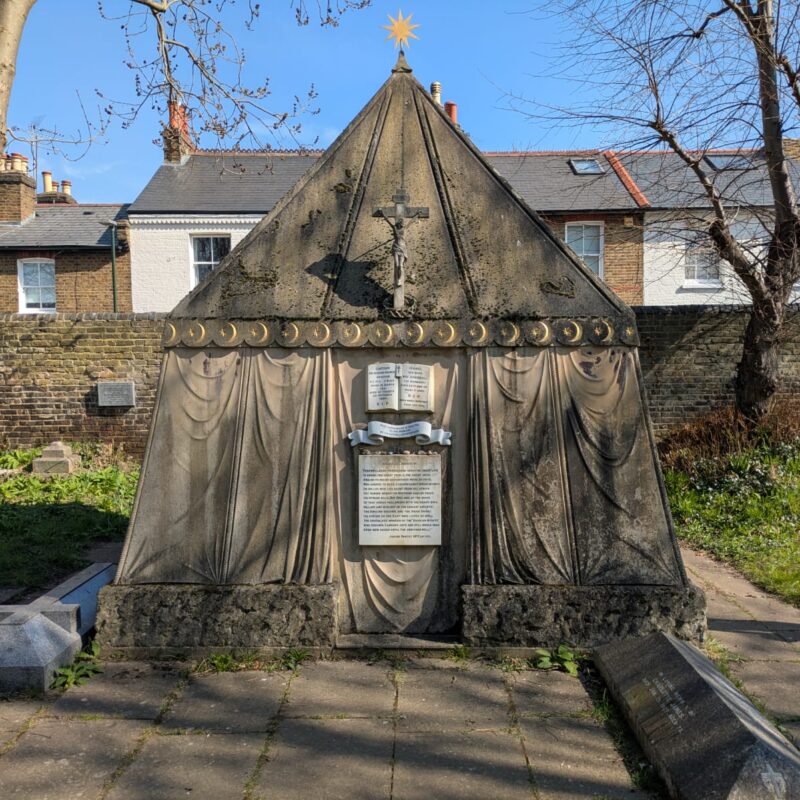 A photograph of the exterior of the tomb which is made of stone and shaped like a nomadic tent.