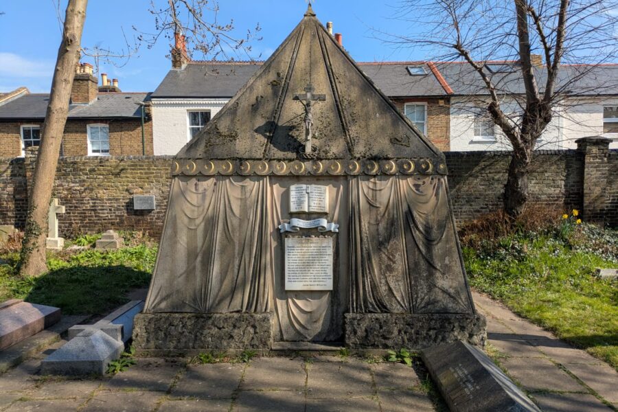 A photograph of the exterior of the tomb which is made of stone and shaped like a nomadic tent.