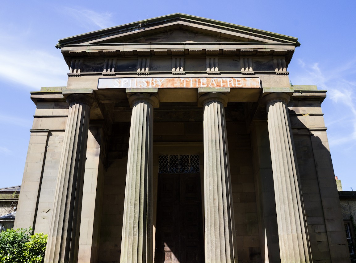 Spilsby House, a heritage building in the style of neo-classical architecture. A building with a Grecian temple style roof, supported by four pillars.