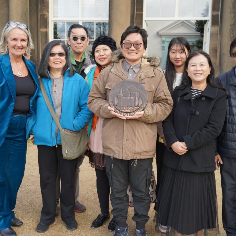 Staff from Wentworth Woodhouse and a group from the Chinese community stand in a group displaying the Europa Nostra award.