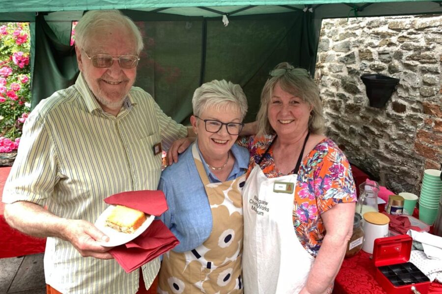 Photograph of three people stood smiling at the Nantgarw China Works' summer open day.