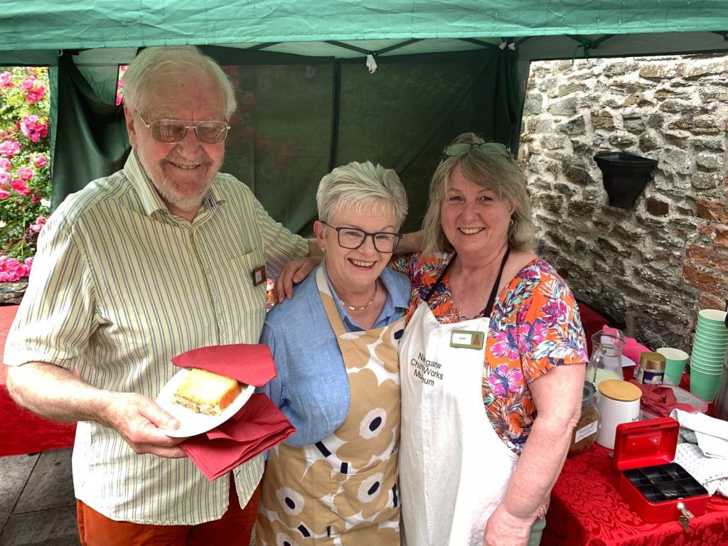 Photograph of three people stood smiling at the Nantgarw China Works' summer open day.
