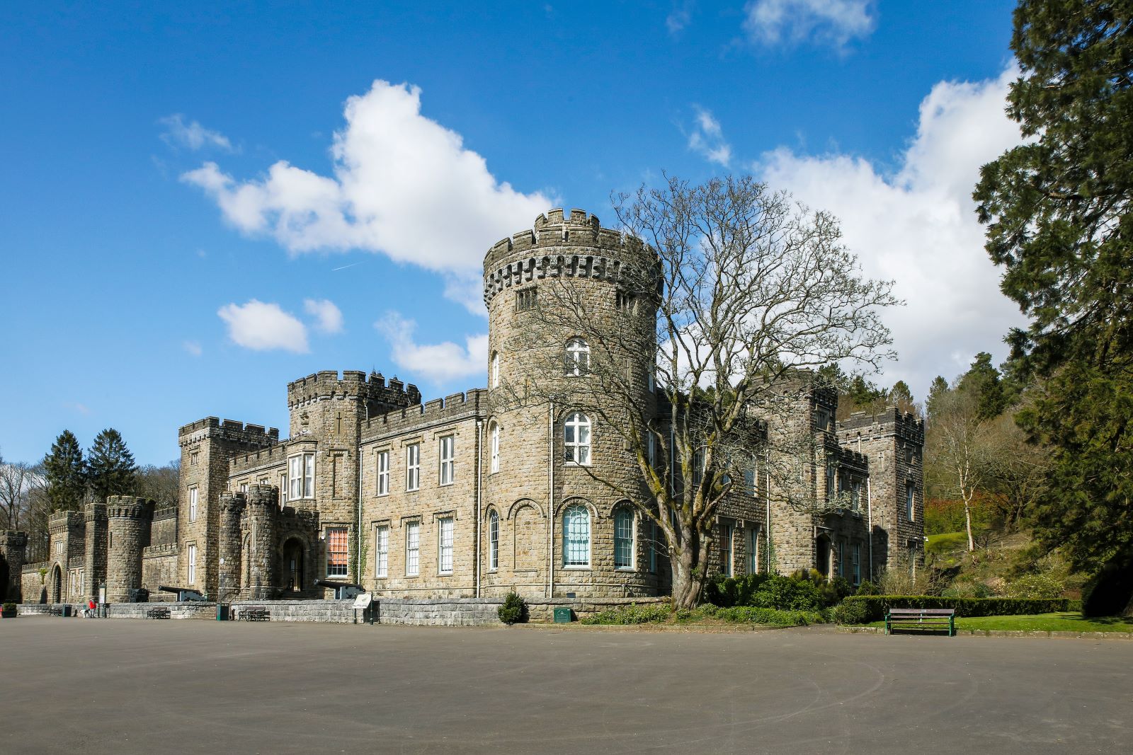 Cyfarthfa Castle with a blue sky in the background with fluffy white clouds.