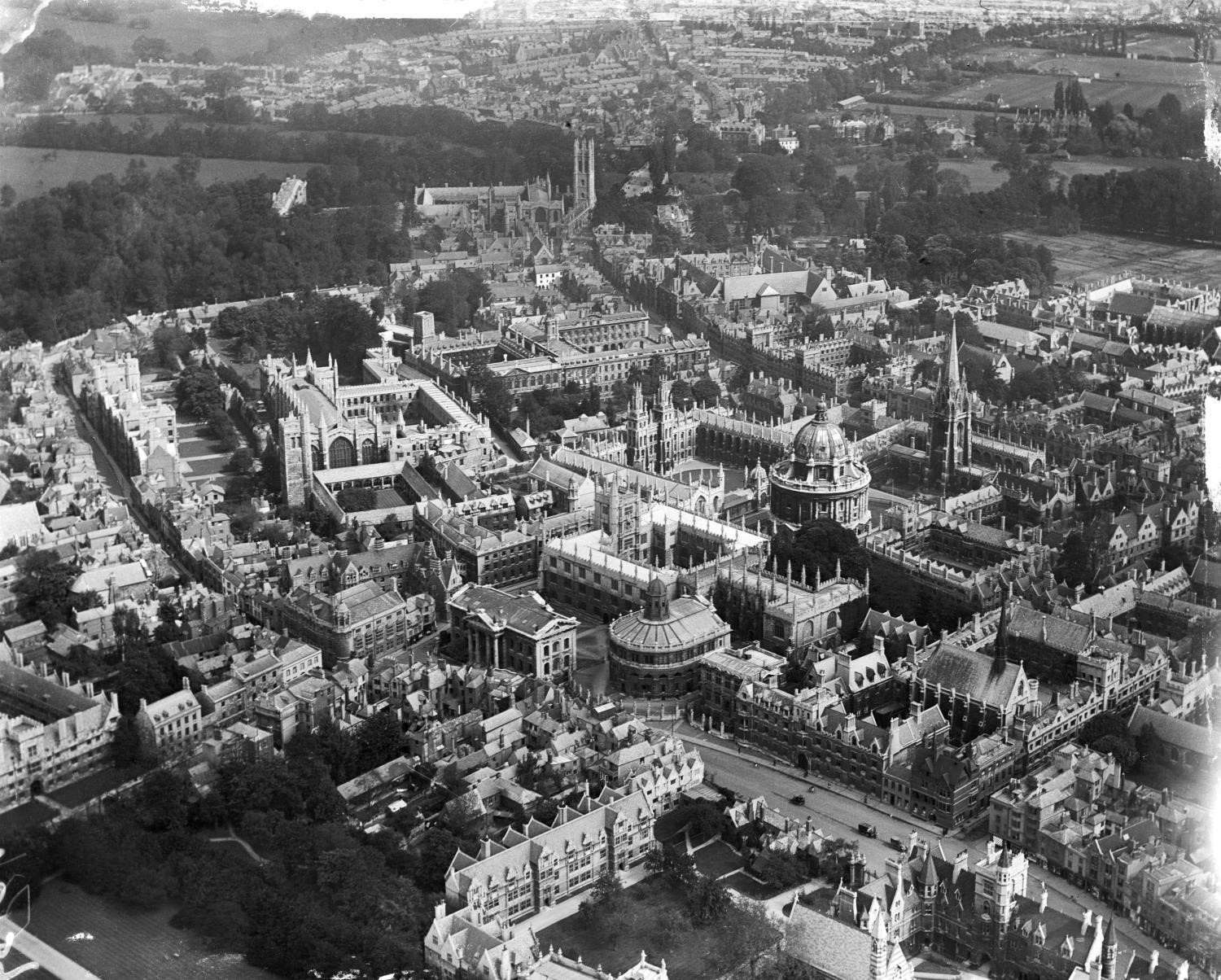 A black and white aerial photograph of a town.