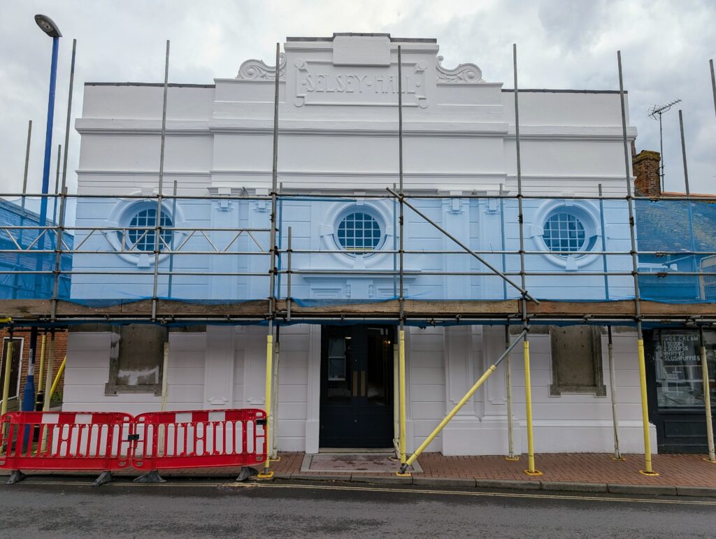 Exterior photograph of the pavilion with scaffolding across its front facade.