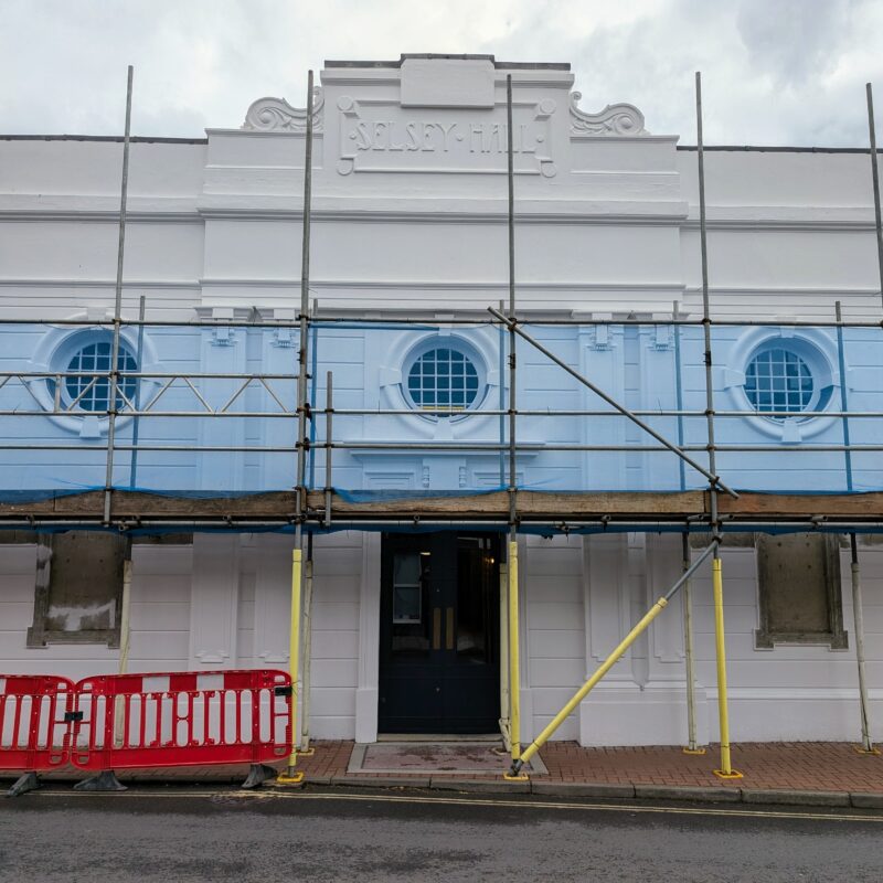 Exterior photograph of the pavilion with scaffolding across its front facade.