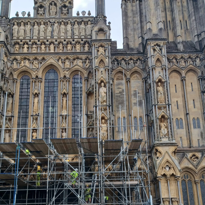 Photograph of Wells Cathedral with scaffolding in the foreground.