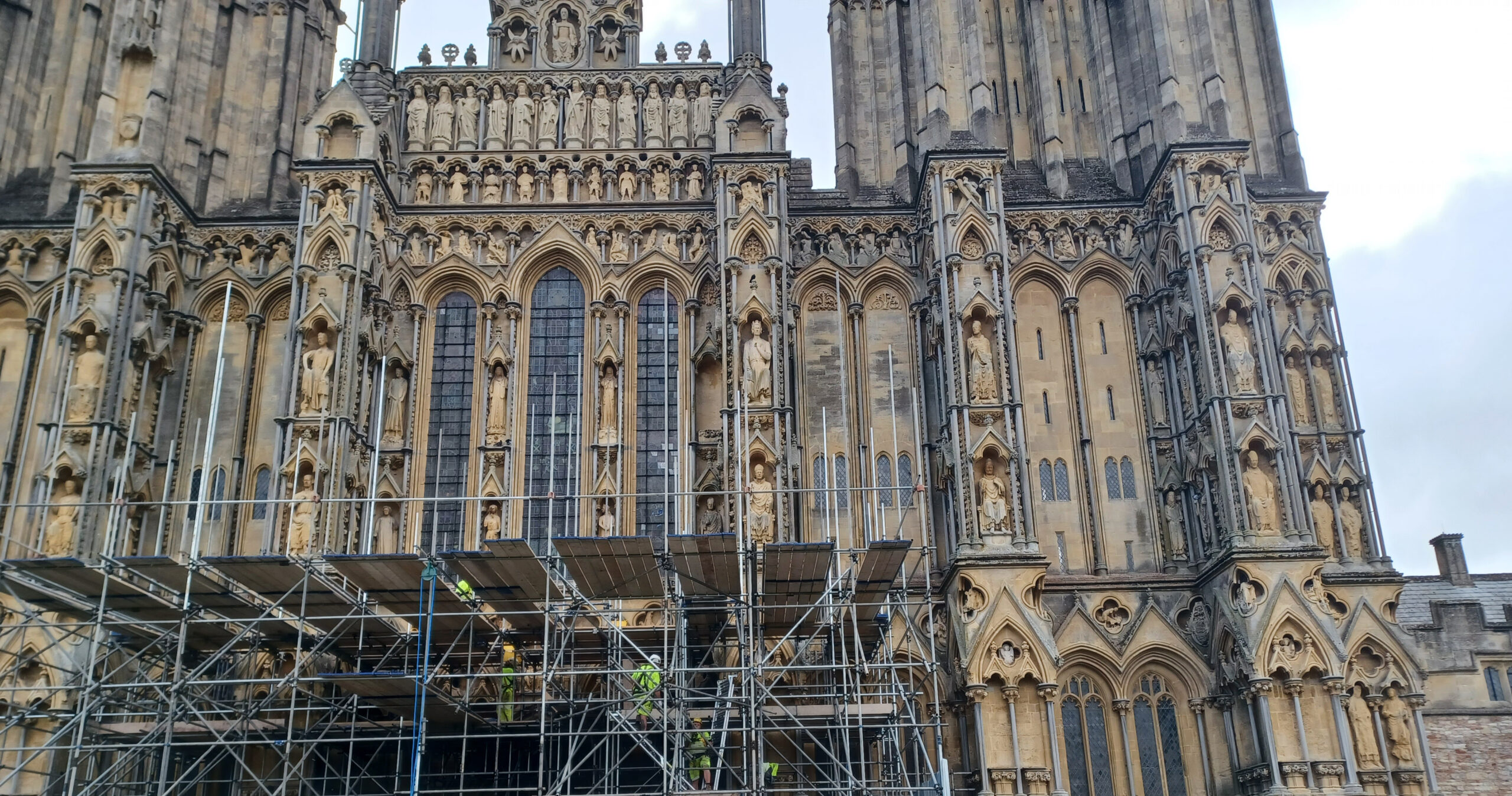 Photograph of Wells Cathedral with scaffolding in the foreground.