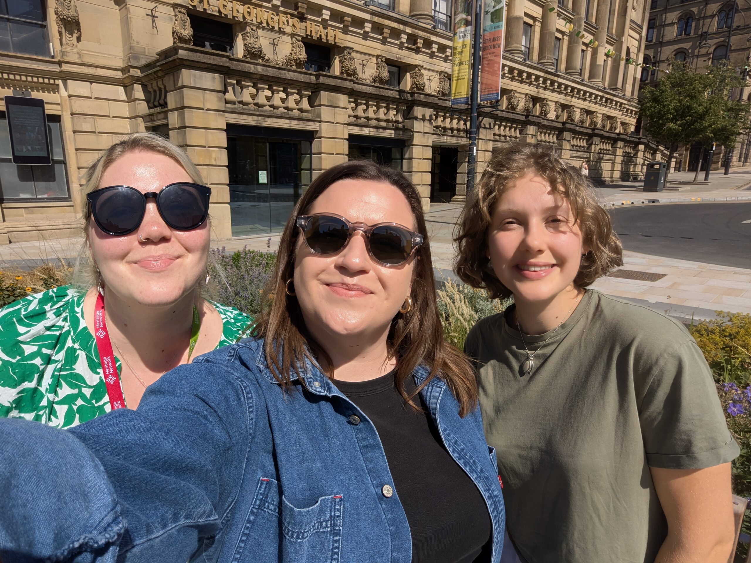 Charlotte, our Development and Outreach Officer for England, smiling in the sunshine in Bradford with Izabella, our Conference Organiser, and Sophie, our Heritage Trainee for England