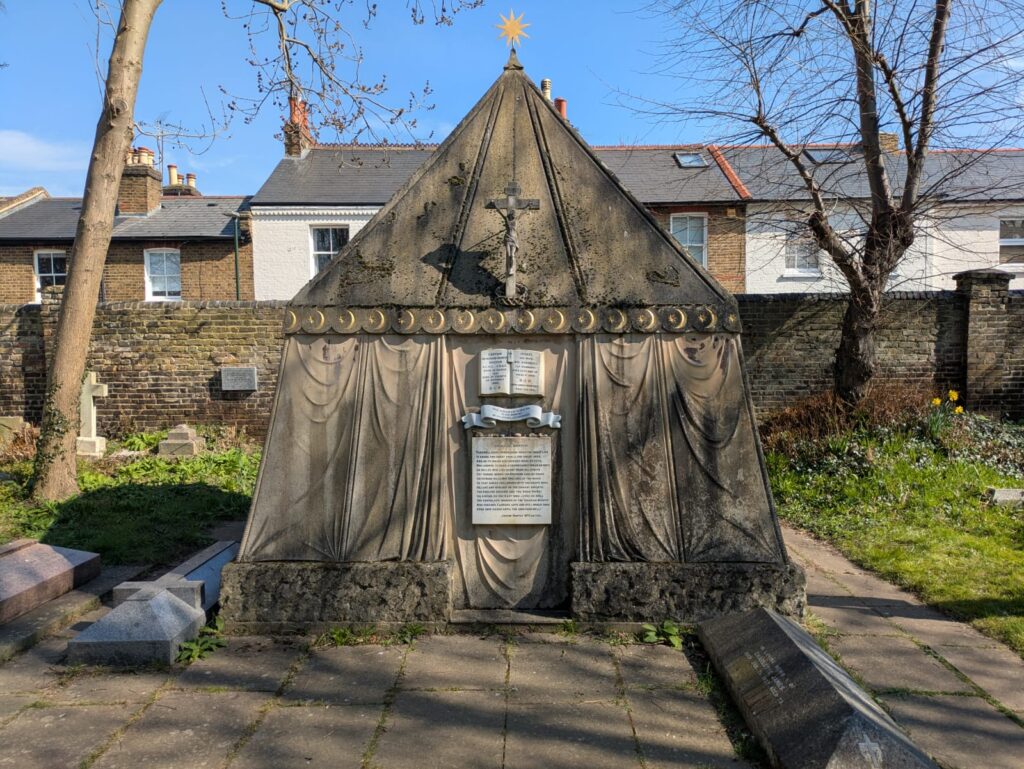 A photograph of the exterior of the tomb which is made of stone and shaped like a nomadic tent.
