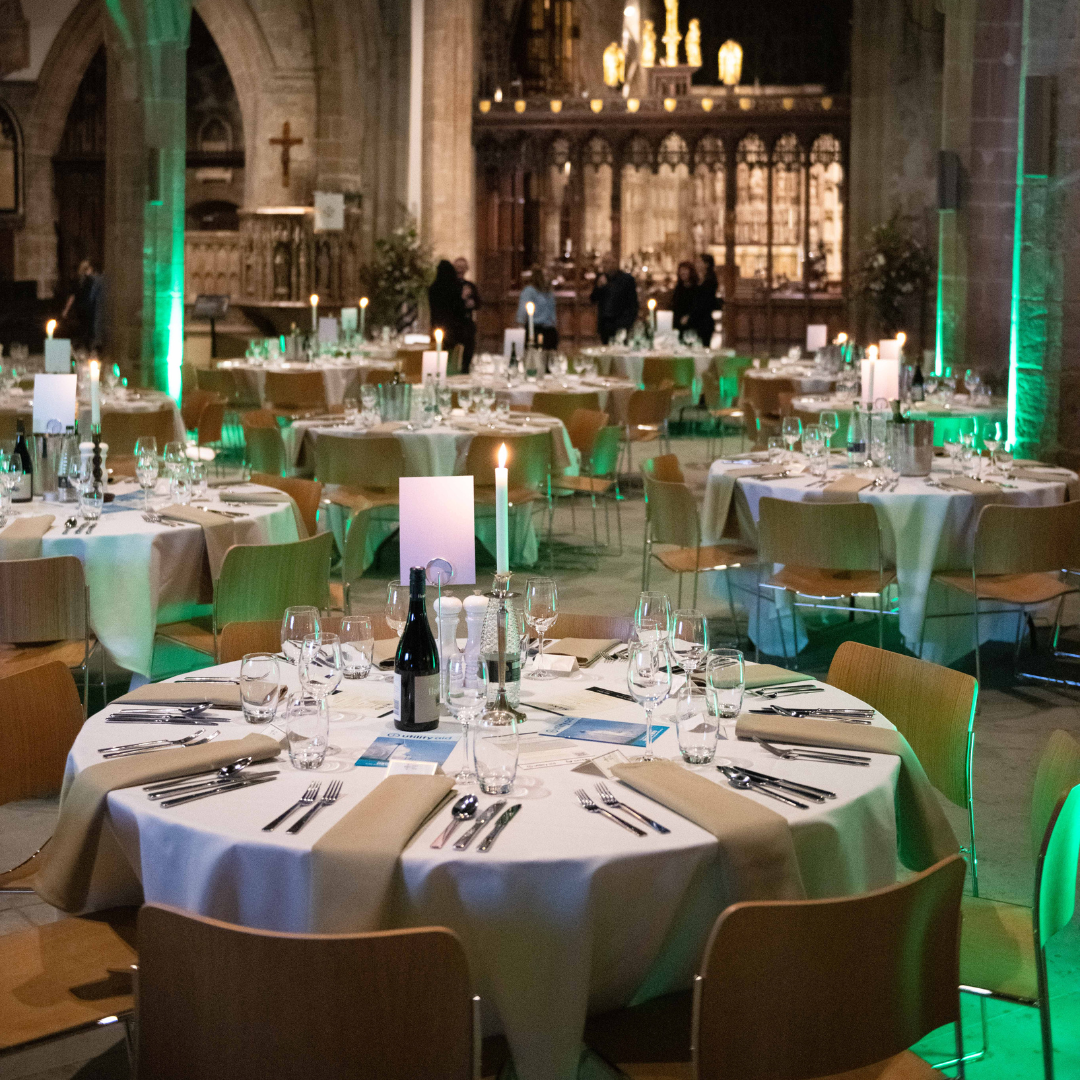 Photograph of round tables laid ready for a conference dinner.